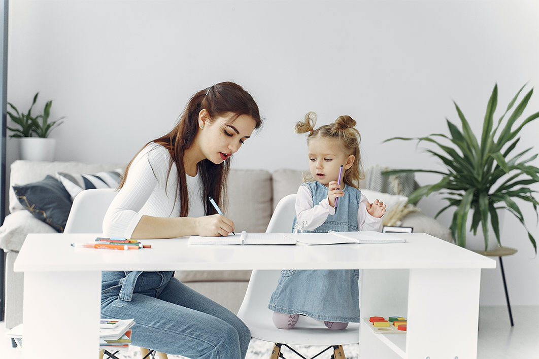 Mother and daughter writing