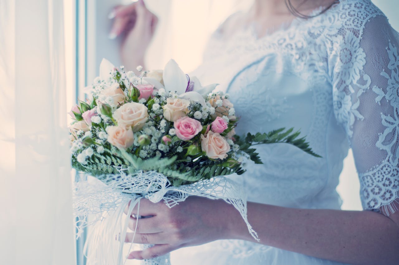 Woman Holding White and Pink Flower Arrangement